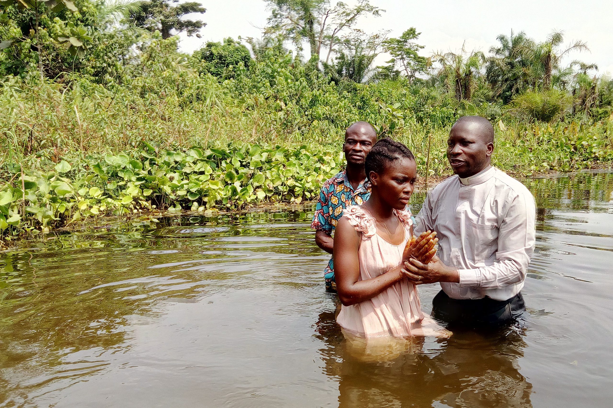 A woman is baptized in the Democratic Republic of Congo