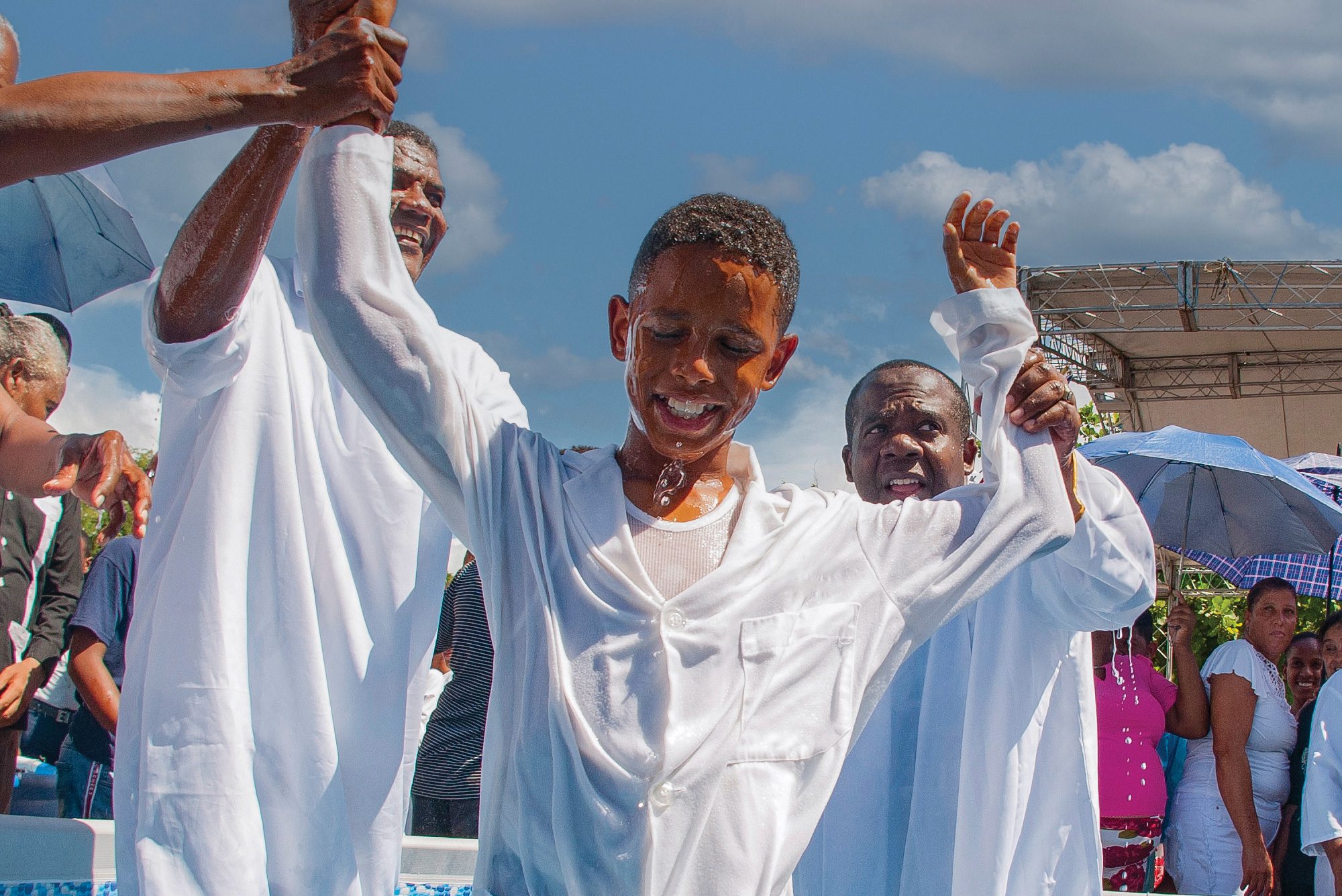 A boy smiles after being baptized