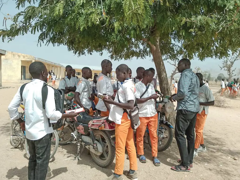 sharing prayer bulletins by motorbike