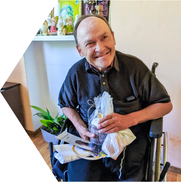 a Ukrainian man smiles after receiving a gift from our Every Home team