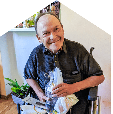 a Ukrainian man smiles after receiving a gift from our Every Home team